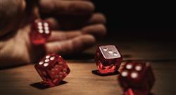 Gaming dice being rolled by hand